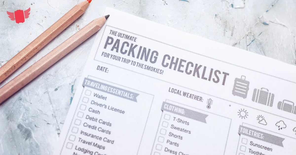 Printed packing checklist with checkboxes and two pencils on a light textured surface